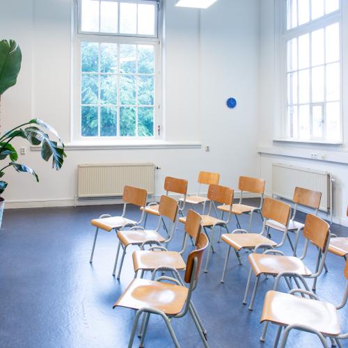 Stoelen in bioscoop opstelling voor een whiteboard. Gezien vanaf de zijkant.